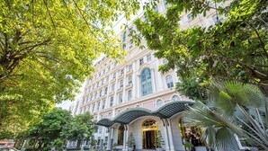 A multi-story hotel with a classic architectural style, featuring arched windows and a central courtyard with a fountain. - Cozrrum Lux - Sonata Imperial (Ho Chi Minh City)