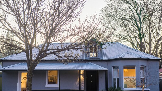 A two-story house with a grey exterior, a metal roof, and a front porch. - LUXURY IN THE HEART OF ORANGE. 1 MINUTE WALK TO BEST CAFES AND RESTAURANTS (Orange)