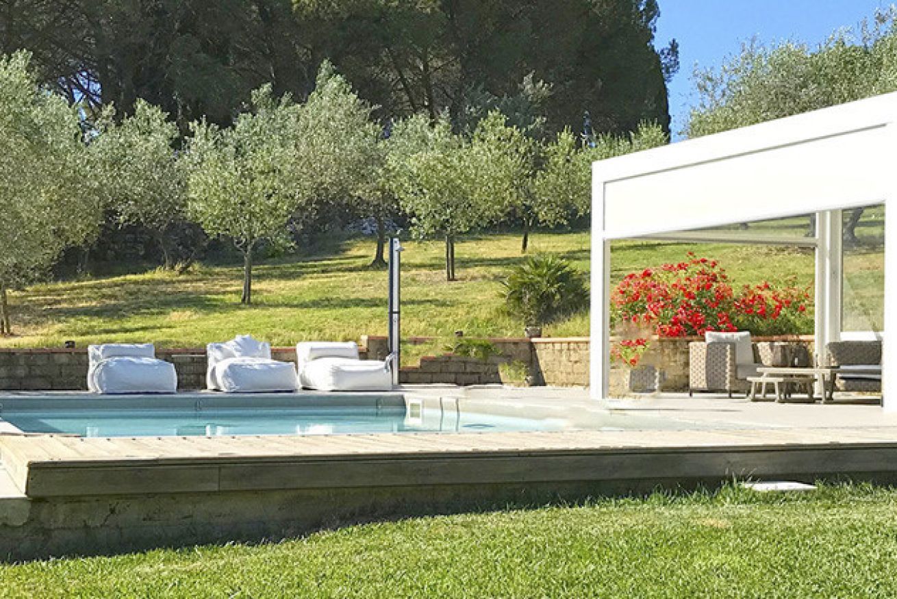 A swimming pool with lounge chairs and a modern outdoor seating area.