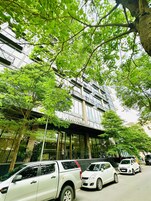 A multi-story building with a modern facade, large windows, and a visible entrance.