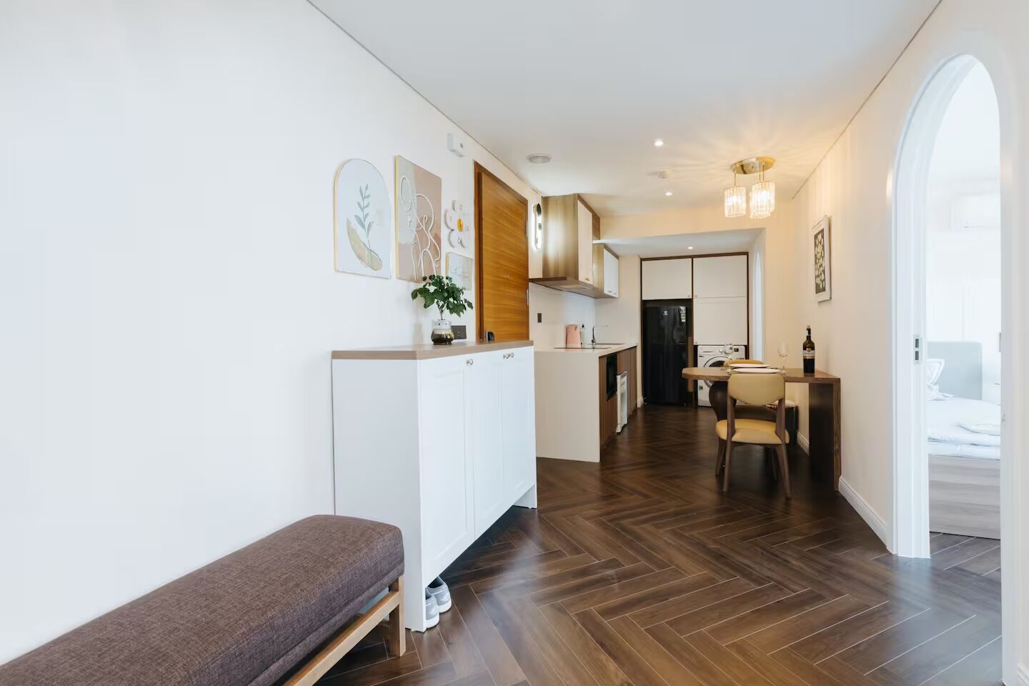 A modern apartment with a kitchen, dining area, and a living space.