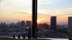 A bathroom with a modern design, featuring a large mirror and multiple faucets. - PentStudio West Lake by Emily in Town (Hanoi)
