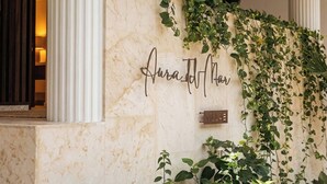 Una pared de mármol con una placa que dice 'Aurad Hotel' y un letrero que indica 'Villa'.