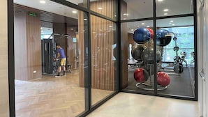 A gym with exercise equipment, including weight machines and exercise balls.