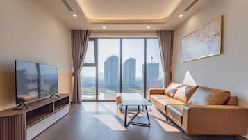 Deluxe Apartment, 3 Bedrooms, Balcony, City View | Living area | 42-inch Smart TV with cable channels