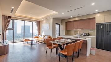 Deluxe Apartment, 3 Bedrooms, Balcony, City View | Living area | 42-inch Smart TV with cable channels