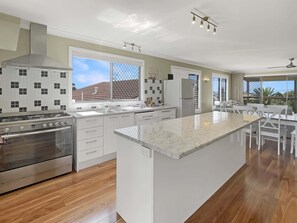 Fridge, microwave, oven, stovetop - Spacious 4-Bed Coastal Home with Water Views (Batehaven)