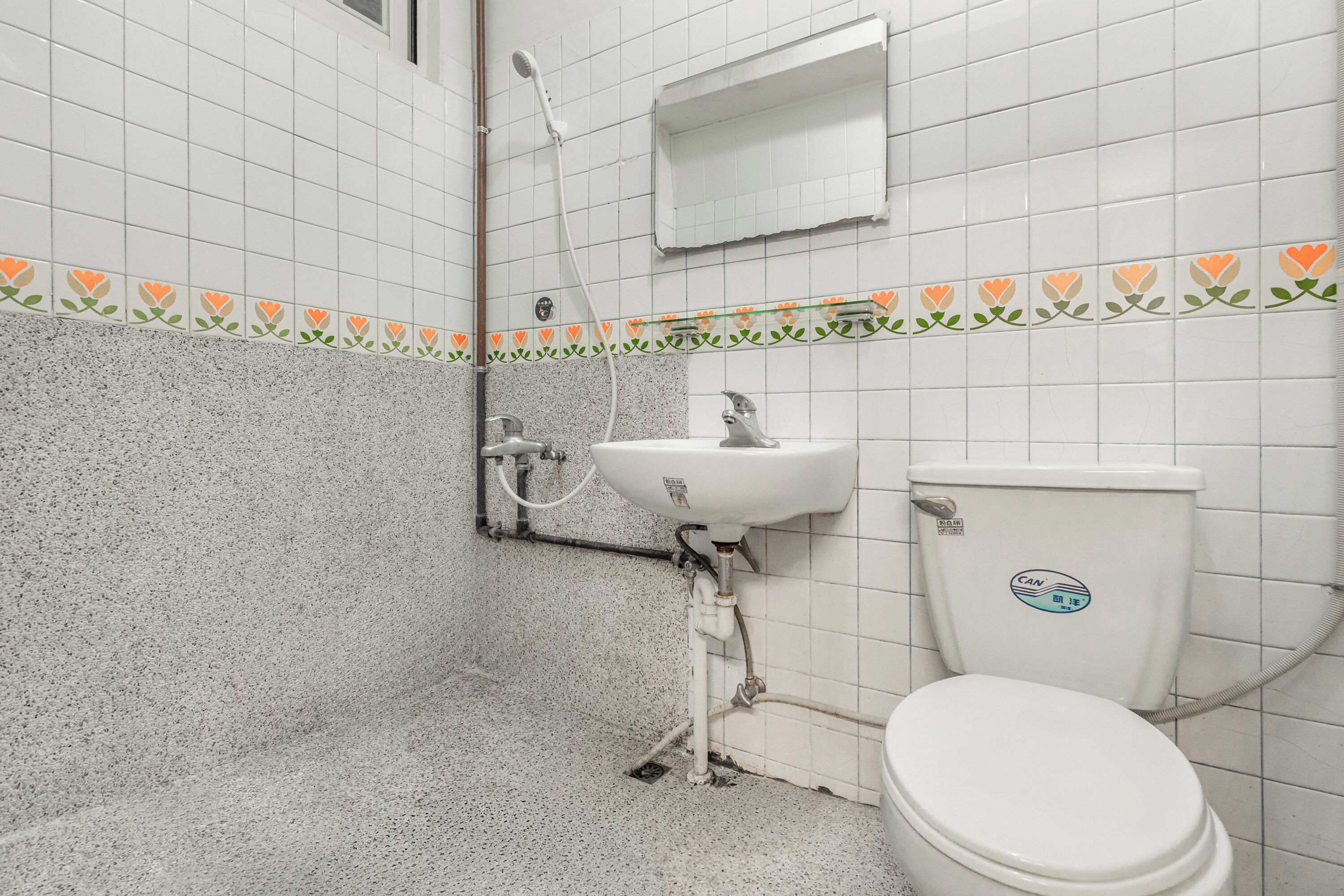 A bathroom with a white sink, toilet, and shower.