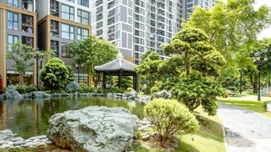 A serene garden with a pond, rocks, and a traditional gazebo. - The Zenpark Tower - Vinhomes Ocean Park (Hanoi)