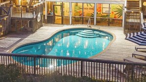A two-story house with a swimming pool, wooden deck, and a restaurant named "Sunside Haven" visible through the windows. - Private Pool 20Steps2Beach Arcade Ping Pong Sleeps18 Barrel Sauna  (Gulf Shores)