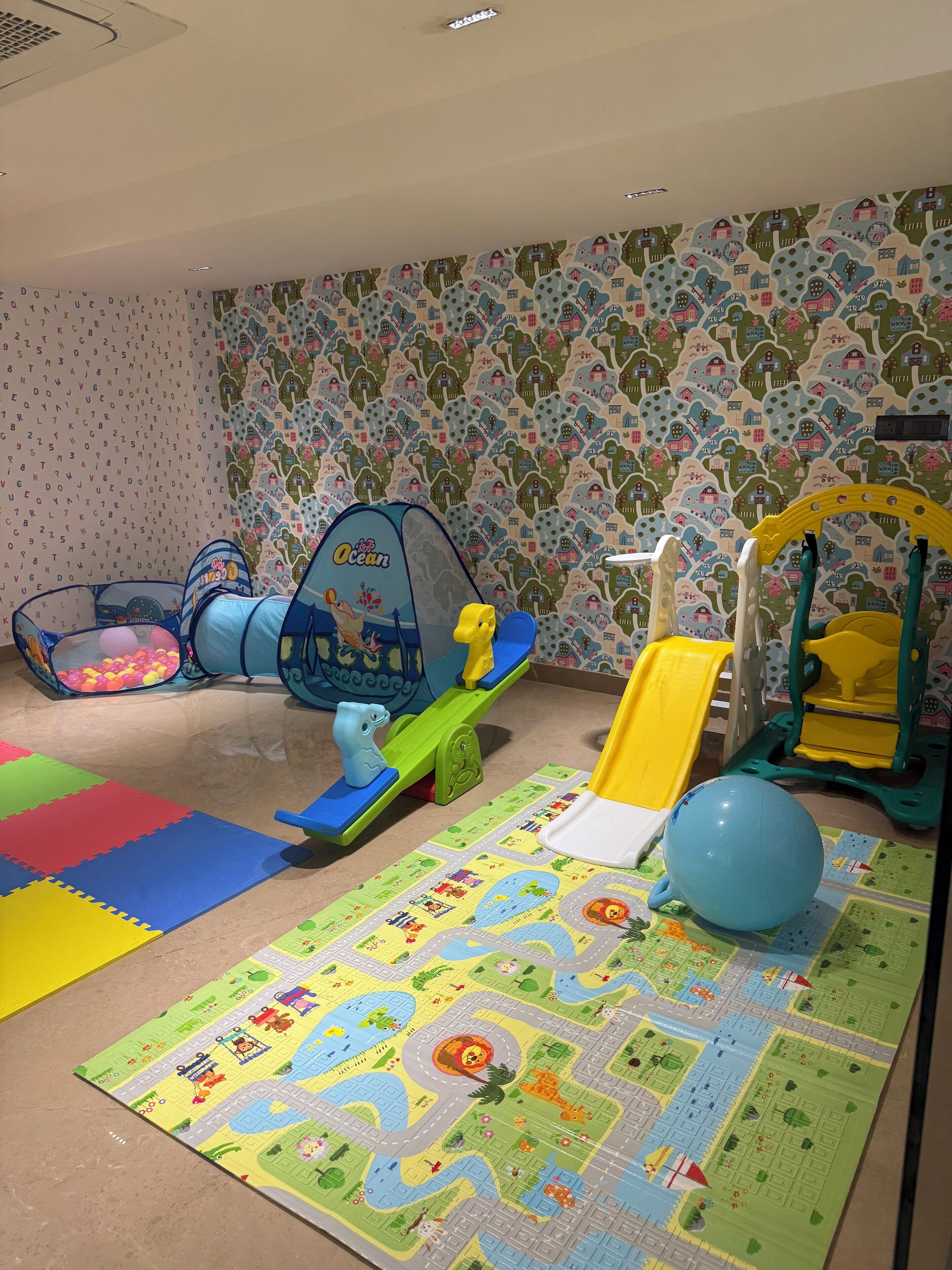 A play area with a ball pit, a slide, and a climbing structure.