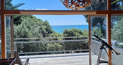 Modern Kiwi family bach right on the beach. Private & pet friendly.