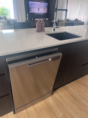 Enjoy cooking in this well-equipped kitchen with a sink and dishwasher.