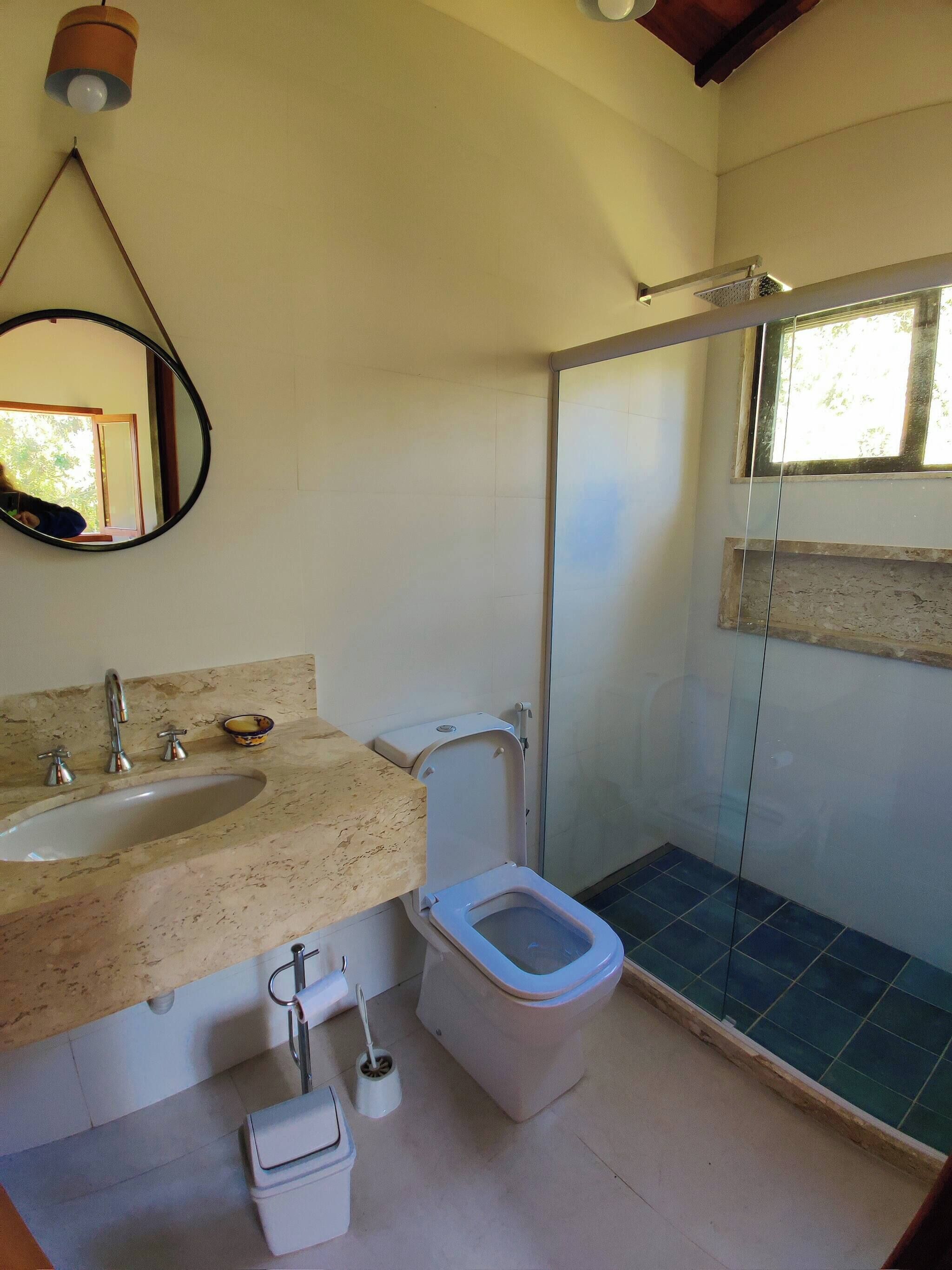A bathroom with a sink, toilet, and shower.