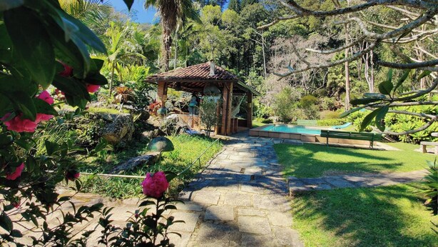 A garden with a gazebo, a swimming pool, and a stone pathway. - Paradisiacal Site in National Park (Teresópolis)