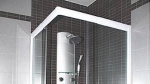 A modern bathroom with a glass-enclosed shower, a toilet, and a sink.