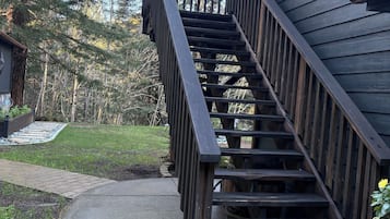 A wooden staircase leading to a house with a 'Welcome' sign on the first step.