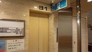 An elevator with a sign above it indicating 'B1'. - Men's only Capsule Hotel Asahi Plaza Shinsaibashi (Osaka)