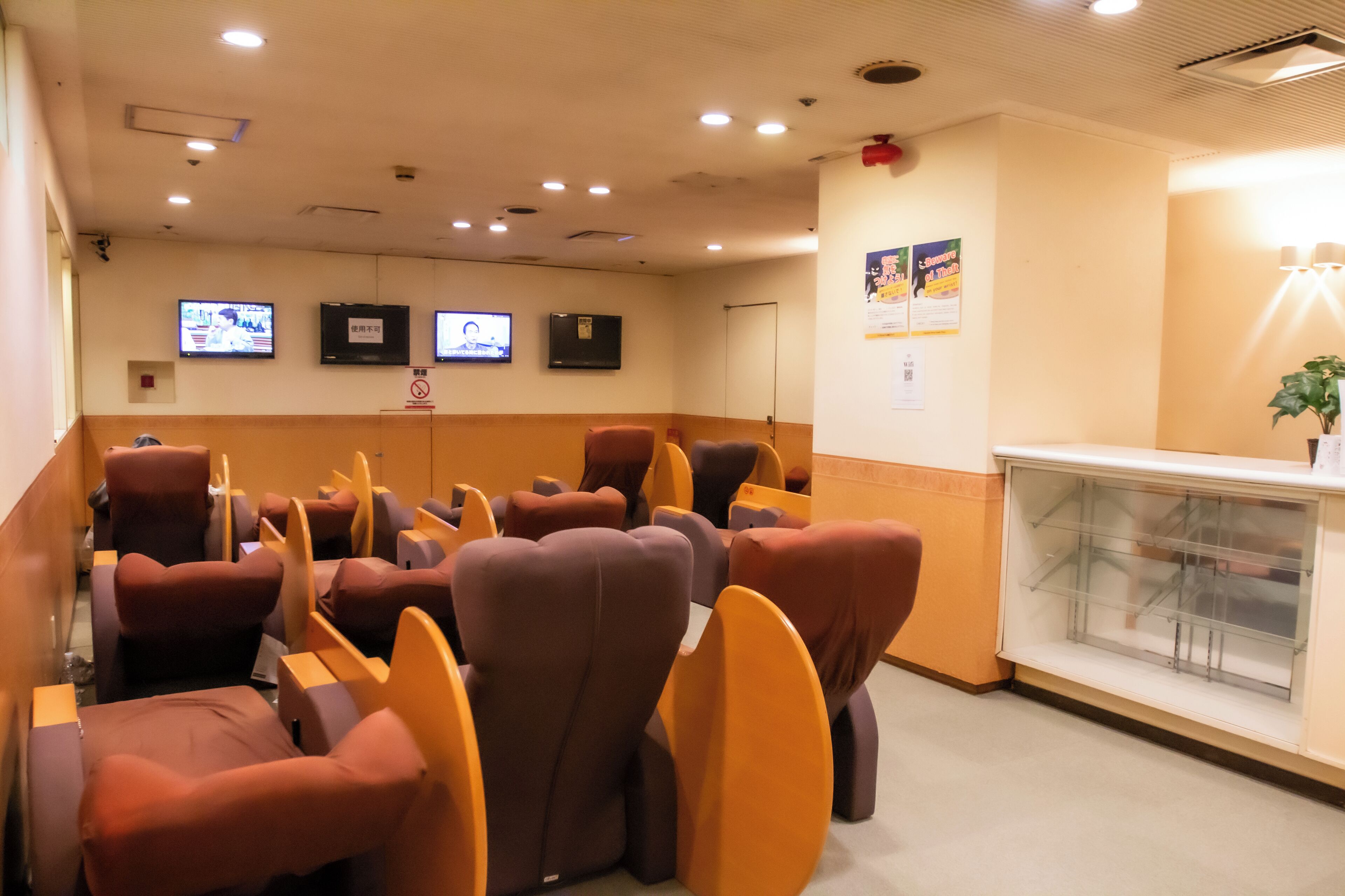 A waiting area with multiple chairs and a reception desk.