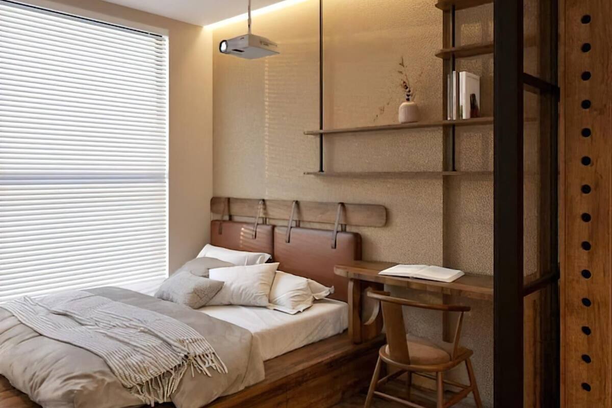Un dormitorio con cama de madera, escritorio y estanterías.