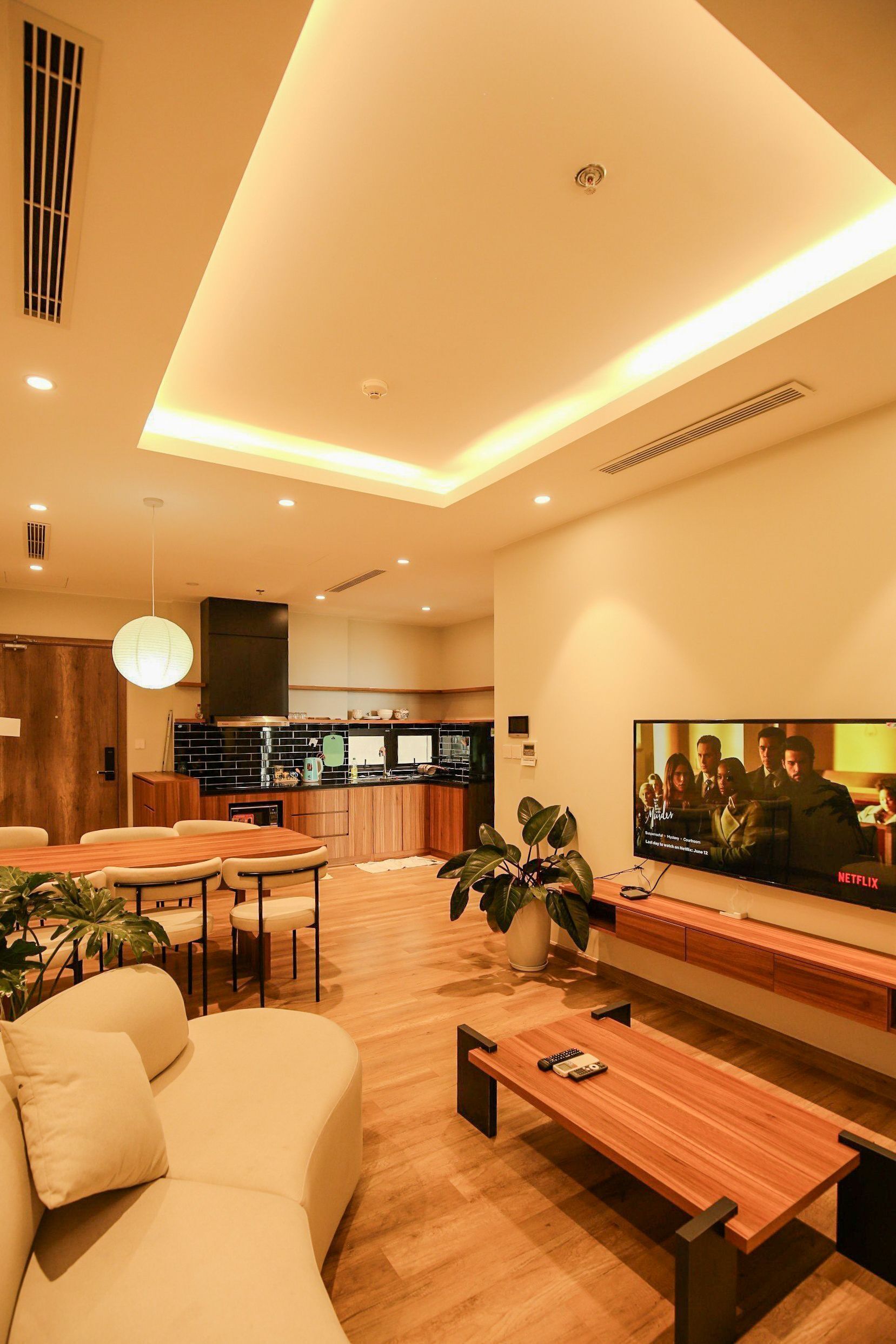 A modern living room with a sofa, coffee table, and TV.