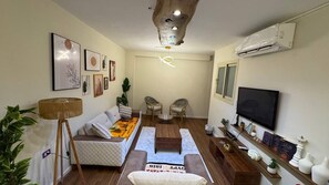 Luksussuite, fjellutsikt | Oppholdsområde | En 43-tommers LCD-TV med Parabol-TV