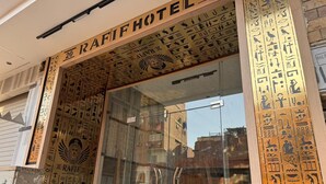 The exterior of the Rafif Hotel with Egyptian hieroglyphs on the facade.