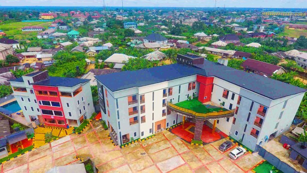A multi-story building with a central courtyard, surrounded by residential houses. - Joddag Hotel and Suites (Eket)