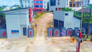 A multi-story building with a central staircase leading to the entrance. - Joddag Hotel and Suites (Eket)