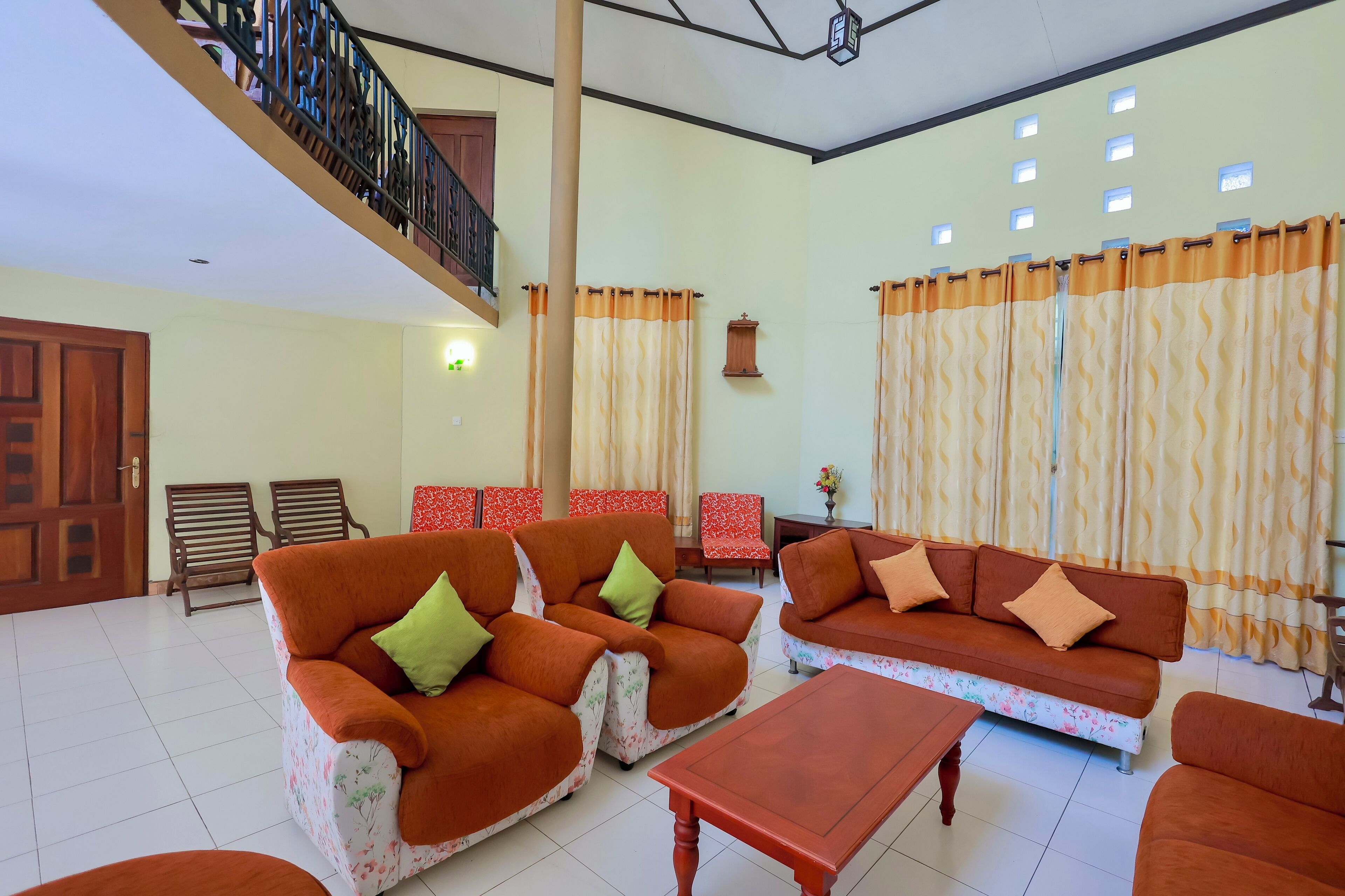 A spacious living area with two sofas, a coffee table, and a staircase.