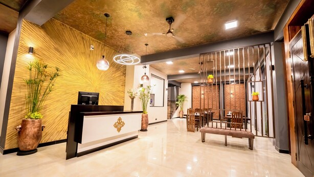 A reception area with a wooden accent wall, a reception desk, and a seating area with a bench.
