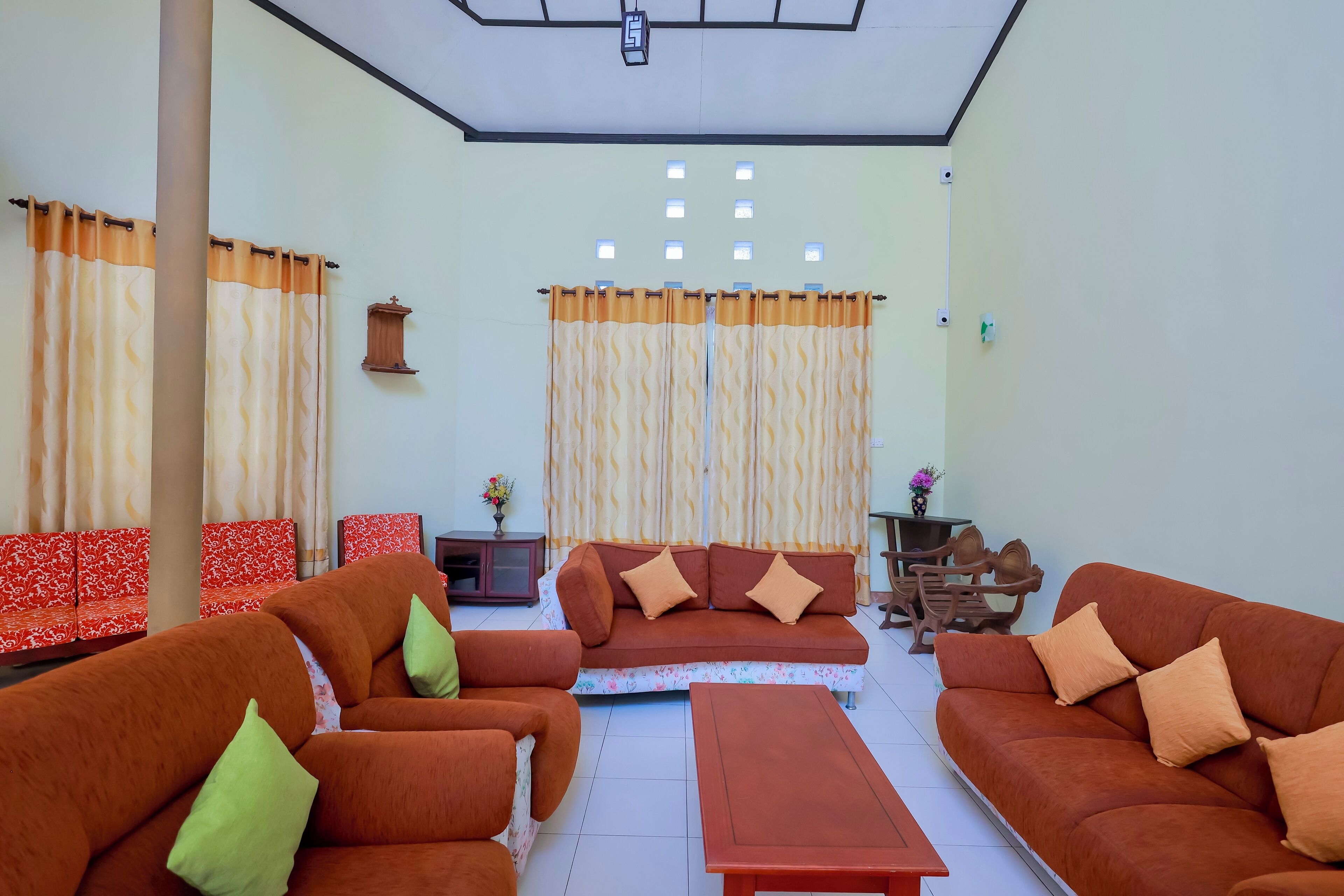 A living room with two sofas, a coffee table, and a small table with a vase.