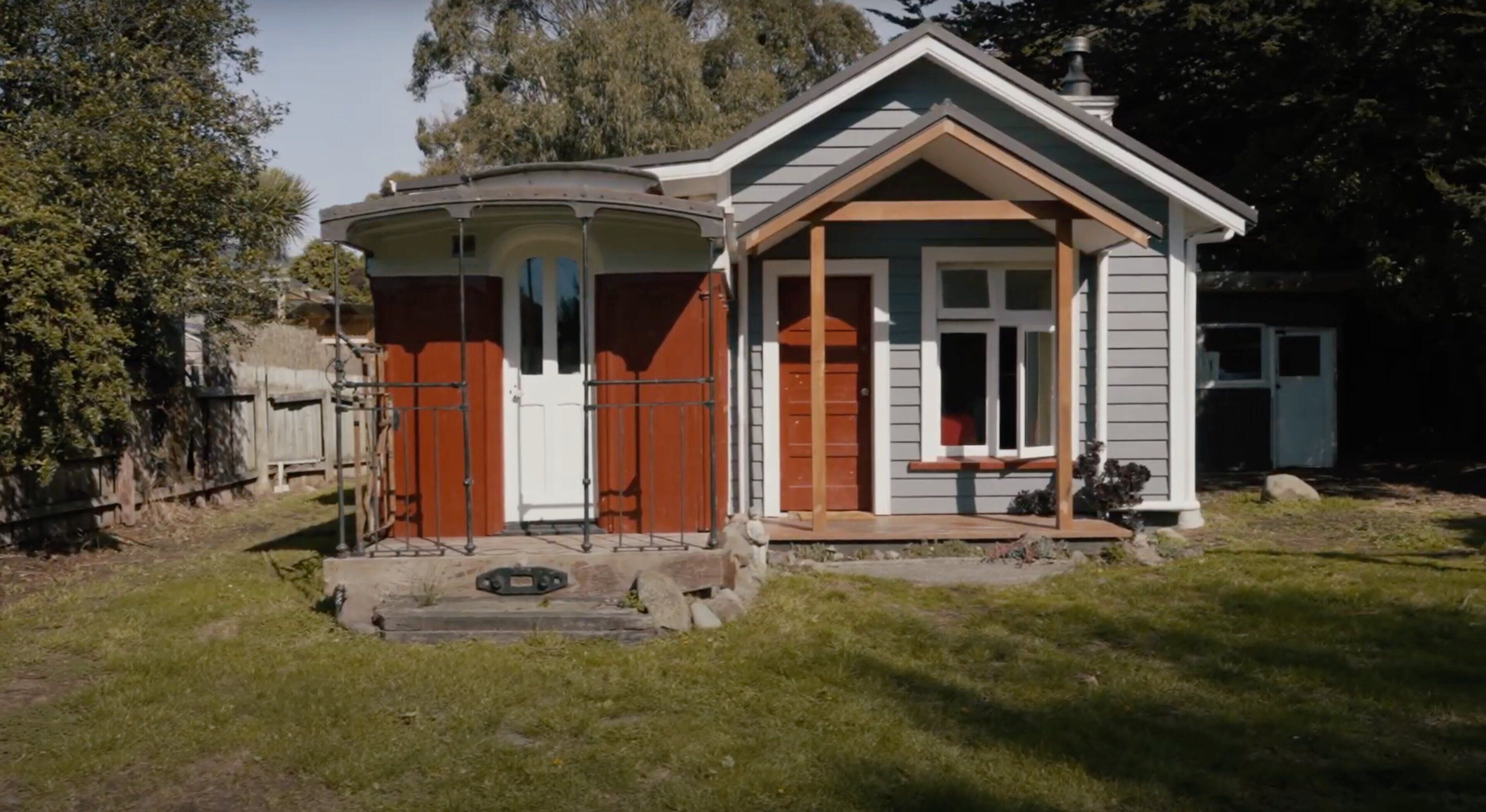 A small, single-story house with a porch and a garage.
