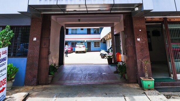 The entrance to Vishnu Residency with a clear sky and a signboard above the entrance. - The Vishnu Residency (Chikkamagaluru)