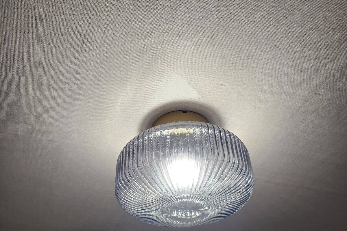A ceiling with a textured, ribbed light fixture.