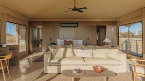 A spacious living area with a sofa, coffee table, and a ceiling fan. - Monarto Safari Resort (Monarto)
