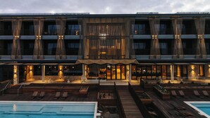 A hotel with a pool area, outdoor seating, and a modern architectural design. - Monarto Safari Resort (Monarto)