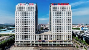 A high-rise building with multiple floors, featuring a prominent sign at the top. - Shanshui S Hotel  (Wuhan)