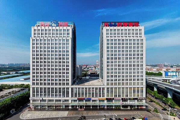 A high-rise building with multiple floors, featuring a prominent sign at the top. - Shanshui S Hotel  (Wuhan)