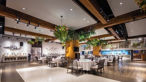 A spacious dining area with high ceilings, wooden beams, and hanging floral arrangements. Tables are set with white tablecloths and chairs. - Shanshui S Hotel  (Wuhan)