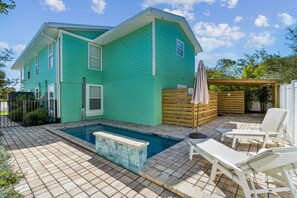 A two-story house with a swimming pool, outdoor seating, and a wooden deck. - Updated 3-bedroom, 2 bath coastal cottage across from the beach UNIT A (Fernandina Beach)