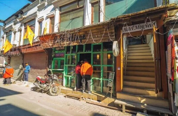 A street view with a building labeled "Hotel Mayfield" and another with a sign for "Mexican American Italian."