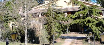 FARMHOUSE SURROUNDED BY GREENERY AND CULTIVATED FIELDS OF VEGETABLES
