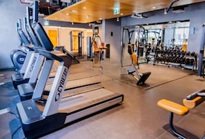 A gym with treadmills, weight machines, and free weights. - Bloomfields 2BR+1 in Mayan (Abu Dhabi)