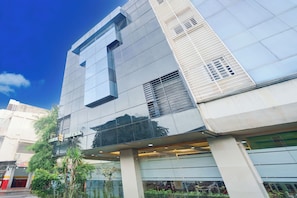 A modern building with a glass facade, large windows, and a visible entrance. - Hotel O Tanjung Duren Near Mall Citraland Formerly Suba Hotel (Jakarta)