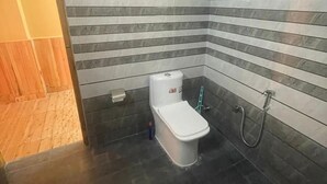 A bathroom with a toilet, a bidet, and a shower. - Boho Riverhouse (Banjar)