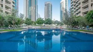 Une piscine entourée d’immeubles d’habitation de grande hauteur.
