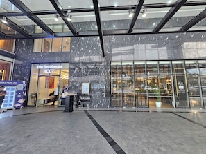 A modern building with a glass facade, a sign for 'The Residences BCCT', and a visible entrance. - The Residences at BCCT by Stays PH (Taguig)
