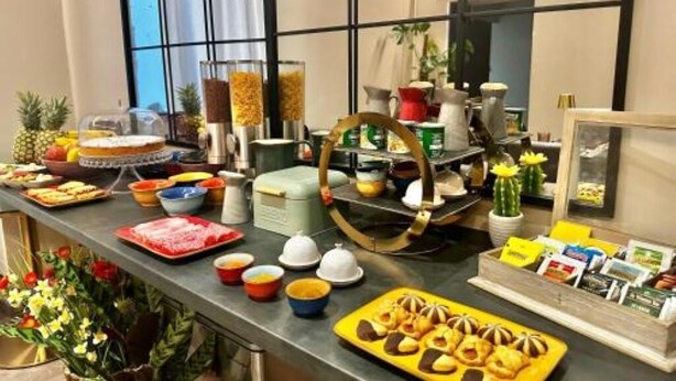 A buffet setup with various food items and condiments.