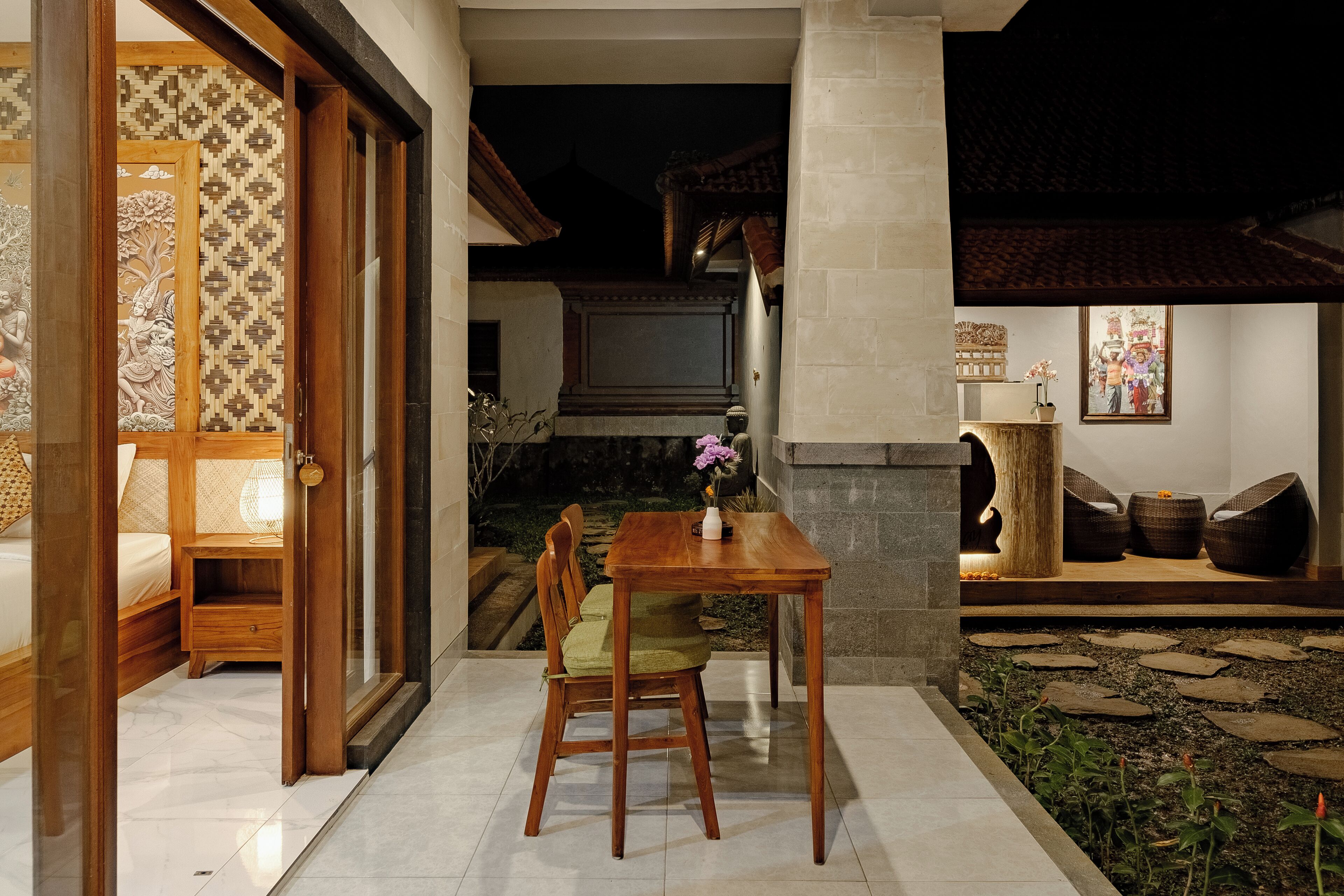 A traditional Japanese-style room with tatami flooring, a low wooden table, and a cushioned chair.